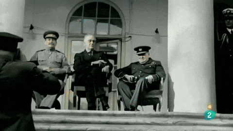 a man is taking a picture of three men sitting on the steps of a building with the number 2 next to them