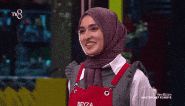 a woman wearing a hijab and an apron with the name beyza on it .