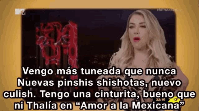 a tv screen shows a woman talking in spanish and the time is 22:10