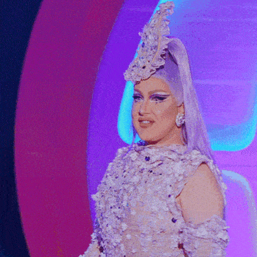 a woman with purple hair is wearing a white dress