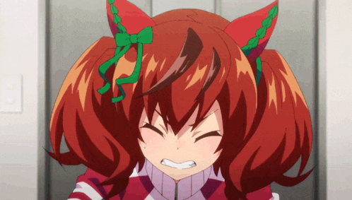 a girl with red hair has a green bow on her ear