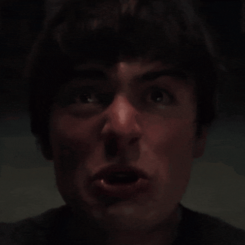 a close up of a man screaming with his mouth open