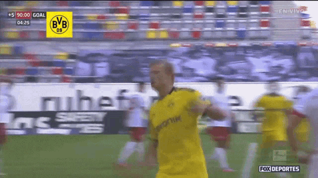 a soccer player wearing a yellow jersey with bvb on the front