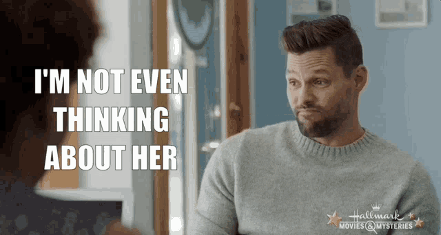 a man with a beard is talking to a woman and says i 'm not even thinking about her