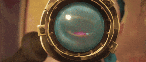 a person looking through a magnifying glass with a blue lens