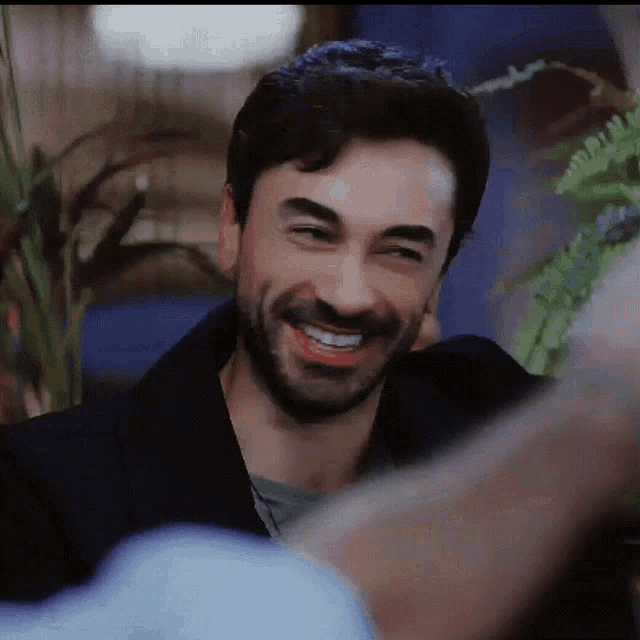 a man with a beard and mustache is smiling