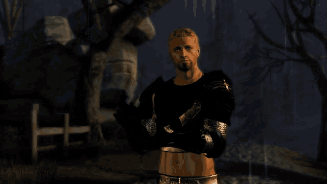 a man with his arms crossed stands in a dark field