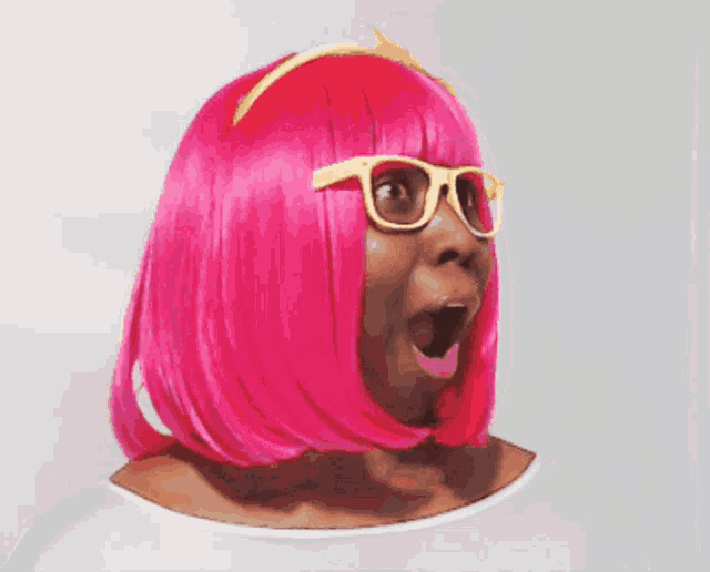 a woman wearing a pink wig and glasses makes a surprised face