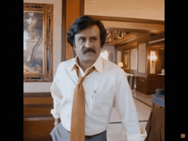 a man with a mustache is wearing a white shirt and a tan tie