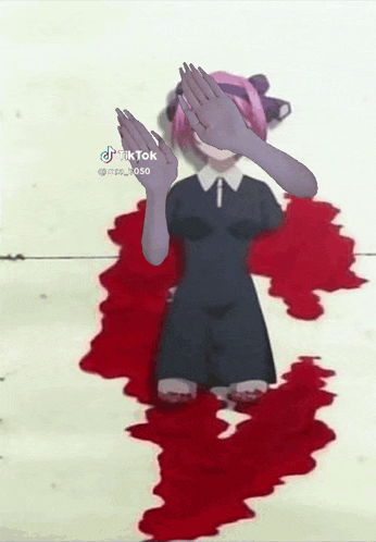 a girl in a black dress covering her face with her hands while standing in a puddle of blood ..