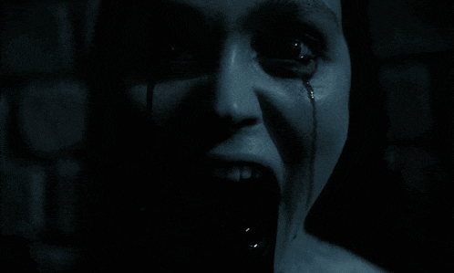 a close up of a woman 's face with a tear running down her eye