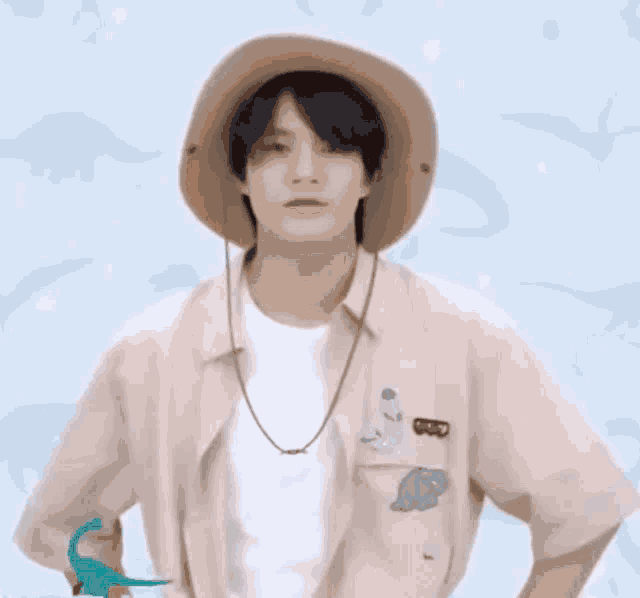 a man wearing a hat with a dinosaur on it .