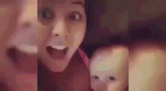 a woman is holding a baby and making a surprised face .