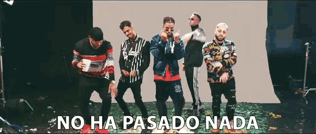 a group of men are dancing with the words no ha pasado nada in the background