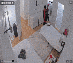 a bedroom with two beds and a picture of the number 3 on the wall