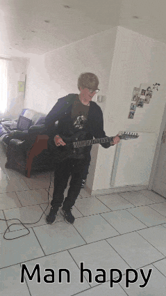 a man is playing a guitar in a living room with the words man happy above him