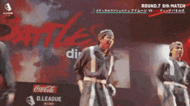 a group of people are dancing in front of a coca cola ad