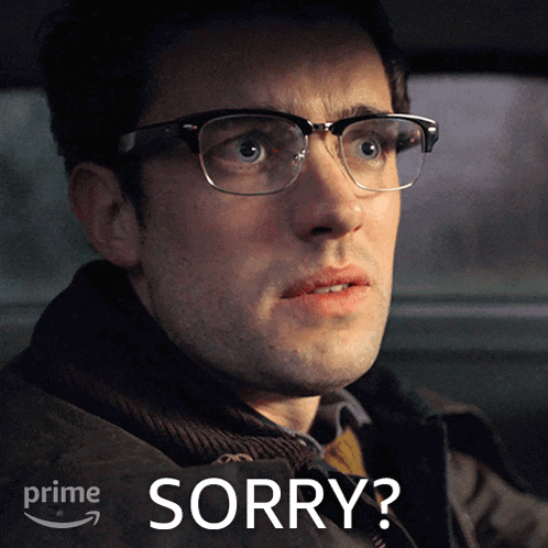 a man wearing glasses says sorry in front of a prime logo