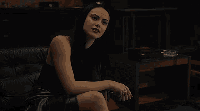 a woman sitting on a couch with her legs crossed