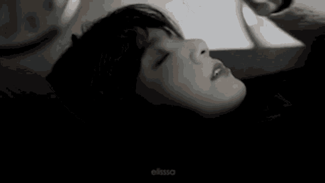 a woman is laying on a bed with her eyes closed and the words " peradin antiz ever " written above her .