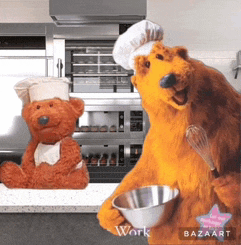 two teddy bears wearing chef hats and aprons are standing next to each other in a kitchen