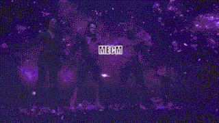 a group of people standing next to each other in a dark room holding hands .