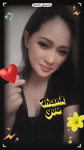 a woman holding a red heart with the words thank you on it