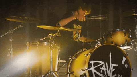 a man playing drums with the word rave on it