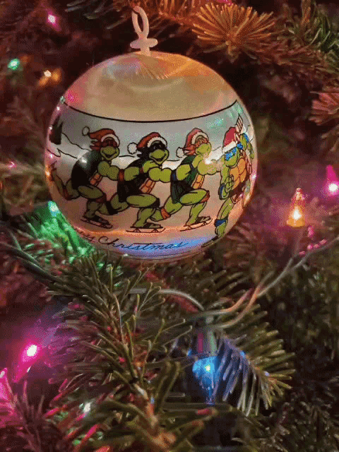 a teenage mutant ninja turtle christmas ornament hangs on a tree