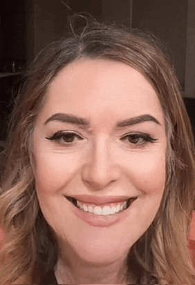 a close up of a woman 's face with a smile on it