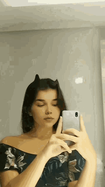 a woman is taking a selfie with her phone