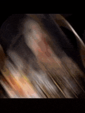a blurred image of a person 's face with a black background