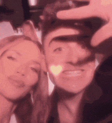 a man and a woman are taking a selfie together .