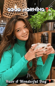 a woman in a green turtleneck is holding a cup of coffee and says good morning
