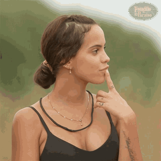a woman with a tattoo on her arm and a sign that says paradise on the bottom
