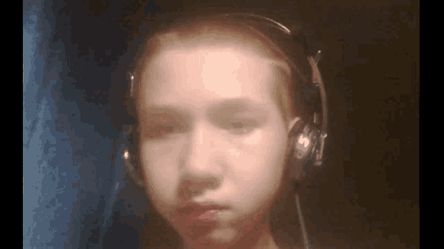 a person wearing headphones looks at the camera