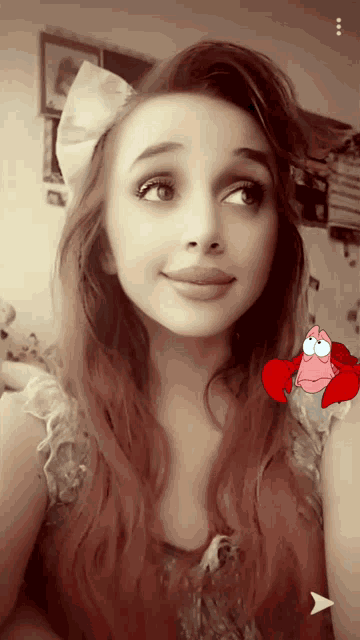a girl with a bow in her hair has a picture of a lobster on her arm