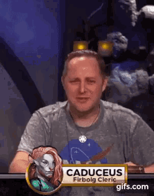 a man with a name tag that says caduces