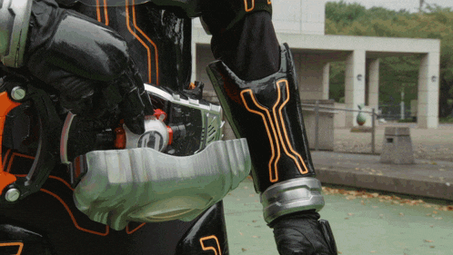a person in a black and orange costume with the letter y on their sleeve