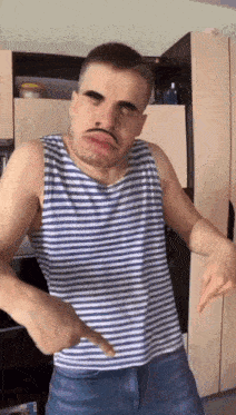 a man wearing a striped tank top with a fake mustache