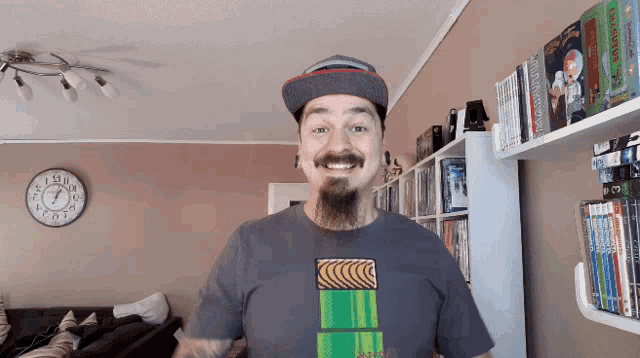 a man with a beard wearing a hat and a t-shirt that says mario
