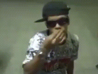 a man wearing a hat and sunglasses is covering his mouth