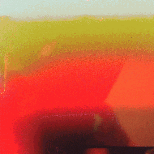 a red and yellow background with a shadow of a person in the corner