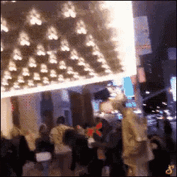 a blurry picture of people standing under a sign that says ' no smoking '