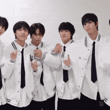 a group of young men wearing white jackets and black ties