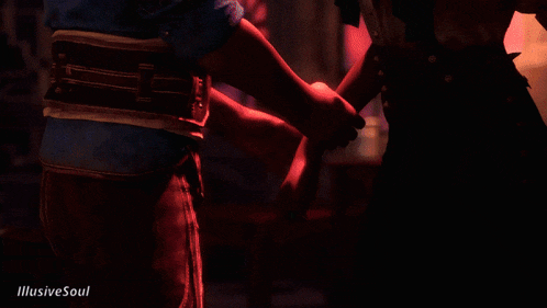 a person holding another person 's hand with illusive soul written on the bottom right