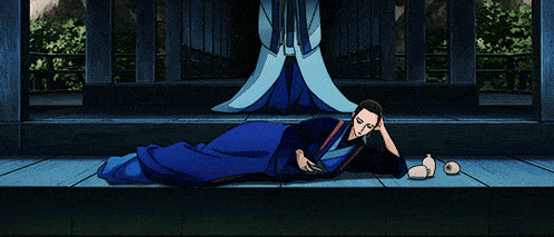 a woman in a blue kimono sits on a wooden deck