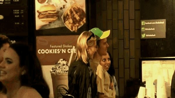 a group of people standing in front of a sign that says cookies 'n cre