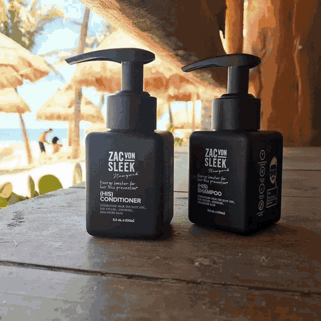 two black bottles of zac von sleek hair products on a wooden table