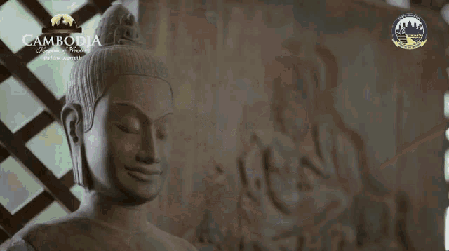 a close up of a statue with a cambodia logo in the background
